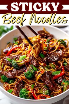 beef noodles with broccoli and peppers in a white bowl