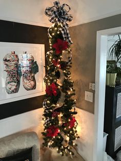 a christmas tree decorated with lights and bows