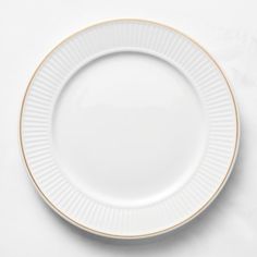 an empty white plate with gold trim