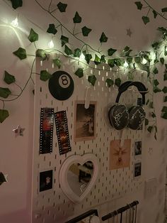 there are many decorations on the wall in this room that is decorated with ivy and lights