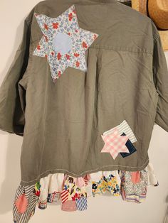 a green jacket with patchwork stars on it