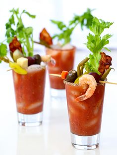 three glasses filled with different types of appetizers