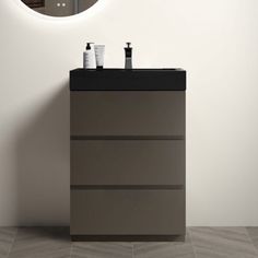 a bathroom vanity with a mirror above it and two soap dispensers on top