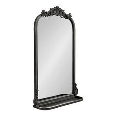 an ornate black mirror is shown on a white background and it's reflection is visible in the mirror