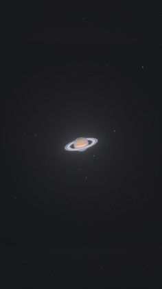 an object in the dark sky with stars around it and a black hole behind it