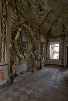 an ornately decorated room with statues and windows