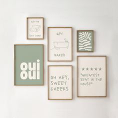 six framed art pieces with different sayings displayed on the wall in various shapes and sizes