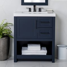 a bathroom vanity with white towels and a mirror