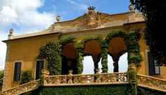 an ornate building covered in vines and greenery