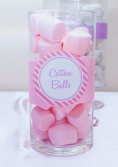 pink and white marshmallows in a clear glass with cotton balls on the side