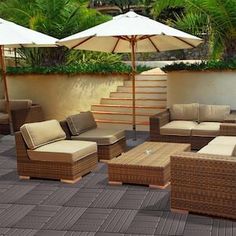 an outdoor patio with wicker furniture and umbrellas