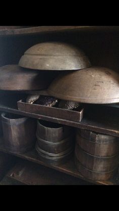 an old kitchen with pots and pans on the shelf next to each other,