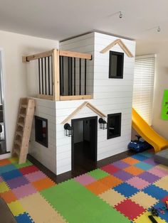 a child's playroom with a slide and climbing stairs