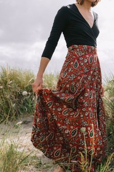 Hand block printed, creating sustainable livelihoods for female artisans. The Maxi Wrap Skirt in Paisley Maroon is seasonless by design. Made from soft, light cotton the wrap skirt is incredibly comfortable, offering style with flattering movement from the waist. Gathers and ties at the side or back of the waist. Crafted with three waist loopholes for an adjustable, flexible fit. Upper ankle Length. Model is 5'8 tall, size UK 10, US 6 and is wearing the S/M. Printed onto 100% cotton. Plant-based Semi Formal Dress Code, Maxi Wrap Skirt, Wrap Maxi Skirt, Fall Capsule Wardrobe, Printed Maxi, Soft Light, Wrap Skirt, Skirt Outfits, Festival Outfits