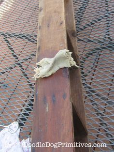 a piece of wood that has been nailed to a metal grate on the ground