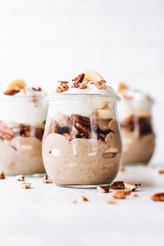 three jars filled with food sitting on top of a table