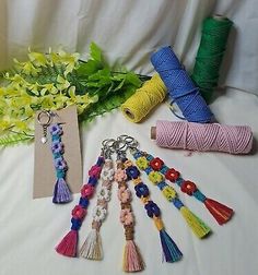 several different types of tassels and flowers on a white table with a card