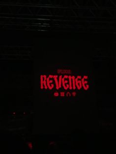 a red neon sign that reads, before kevenge on the side of a black stage