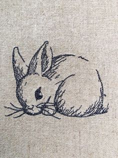 a drawing of a rabbit laying down on the ground