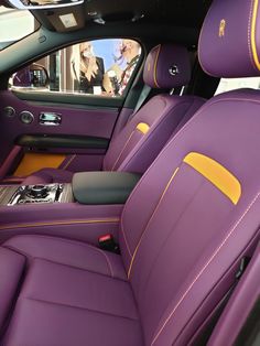 the interior of a car with purple leather and yellow stitching on the front seats