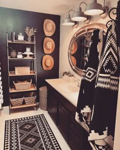 a black and white rug in a bathroom next to a sink with a mirror above it