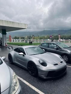 two cars parked in a parking lot next to each other