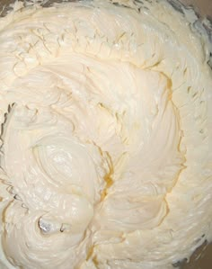 a bowl filled with whipped cream sitting on top of a table