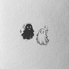 two black and white ghost stickers on paper