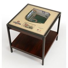 a wooden table with a glass top and baseball field in the middle on it's shelf