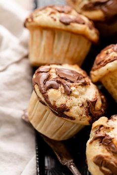 chocolate chip muffins are sitting on a plate