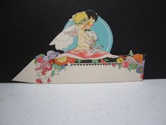 a card with an image of a bride and groom on top of it, sitting on a table