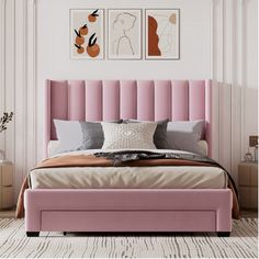 a bed with pink headboard and pillows in a room next to two pictures on the wall