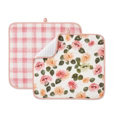 two pot holders with flowers on them and one has a pink gingham design