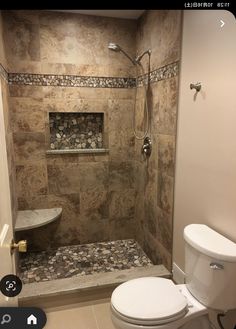 a bathroom with a walk in shower next to a toilet