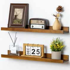 two wooden shelves with pictures and decorations on them