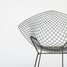 a black wire chair sitting on top of a white floor