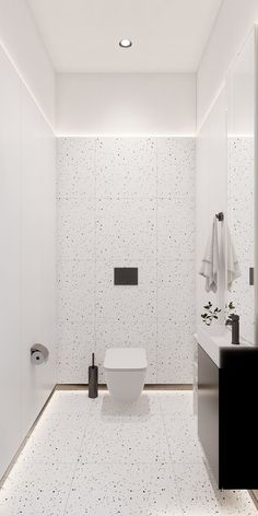 a white bathroom with black and white decor