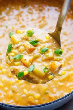 a spoon full of soup with corn on the cob