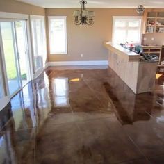 an empty kitchen and living room with sliding glass doors leading to the dining room area