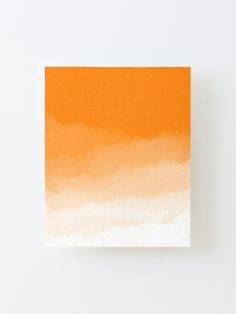 an orange and white painting on a wall