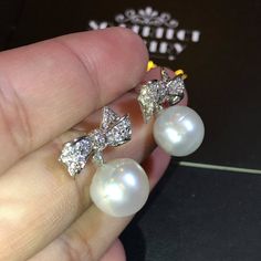 We are presenting you A PAIR OF matching SOUTH SEA PEARLS with LUSTROUS WHITE color. SET IN HANDCRAFTED, 18K SOLID GOLD DROP EARRINGS. ACCENTED WITH 64 E/VS, SPARKLING ROUND BRILLIANT DIAMONDS! IN CASE OF RETURN FOR US BUYERS. BUYERS MAY SEND THE ITEMS BACK TO OUR US-BASED OFFICE IN SALT LAKE CITY, UTAH ONLY ONE ITEM AVAILABLE!! NO DUPLICATES!! WHAT YOU SEE IN THE PICTURES IS WHAT YOU WILL GET SOLIDLY HANDCRAFTED EARRINGS! SUGGESTED RETAIL VALUE: $9,880 PEARLS: Size: 12 mm Shape: Oval/Round Colo Cubic Zirconia Round Pearl Earrings For Party, Pearl White Pear-shaped Party Jewelry, Classic White Pearl Earrings For Party, White Cubic Zirconia Party Earrings, Teardrop White Gold Bridal Earrings For Party, White Pear-shaped Party Jewelry, Luxury Silver Bridal Earrings As Gift, Elegant Diamond Pearl Earrings For Parties, Elegant Diamond White Pearl Earrings For Party