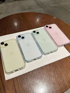 three iphone cases sitting on top of a table