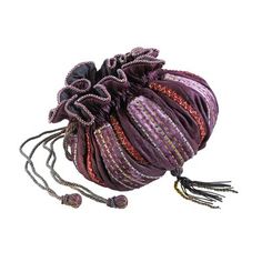 a small purple bag with tassels on the bottom and two strings attached to it