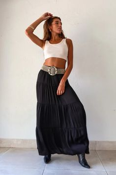 Black satin maxi skirt with an elastic waist band. Lined and 
runs true to size, Sofia wears size Small. Polyester, Hand wash cold. Paired with the Michelle Crop Top, and the OZ Beaded belt. #skirtfashion #fashion #crop #cropped #top #long #maxiskirtoutfitsummer #summer #shopmycloset #tiktok #ideas #instagram #inspiration #aesthetic #travel #vacation #clothes #closet Chic Black Rayon Skirt, Chic Black Maxi Dress With Tiered Skirt, Chic Rayon Tiered Maxi Skirt, Chic Black Tiered Skirt Maxi Dress, Chic Rayon Maxi Skirt With Elastic Waistband, Black Flowy Rayon Skirt, Black Rayon Flowy Skirt, Flowy Black Rayon Skirt, Black Maxi Dress With Elastic Waistband