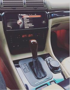 the interior of a car with an automatic gear lever and radio in it's center console