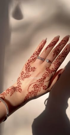 a woman's hand with henna on it