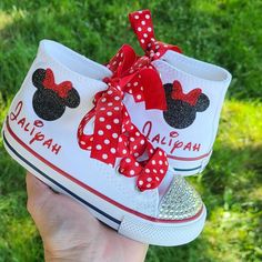 White high tops Converse with a black glitter Minnie head and red bow along with her name in red glitter. Available in sizes 2-10 infant/toddler. I get asked a lot, so YES, these are hard bottoms in every size. :) Minnie Mouse Converse, Shark Shoes, Minnie Mouse Shoes, Minnie Mouse 1st Birthday, Pink Minnie, Personalized Shoes, White High Tops, Sneakers Athletic, Minnie Mouse Birthday