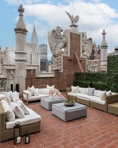 an outdoor living area with couches, tables and chairs on top of a roof