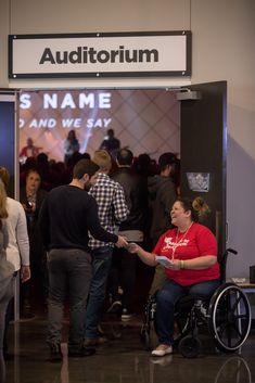 a group of people standing around each other