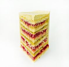 a stack of four slices of cake sitting on top of each other in front of a white background